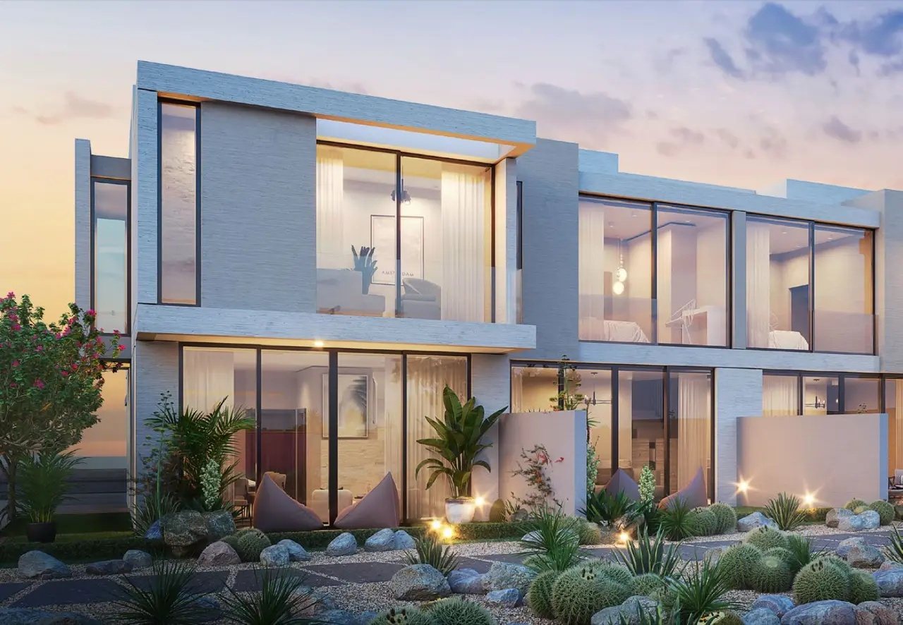 Two-storey AIDA Oceana villas at dusk with a desert garden